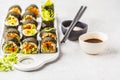 Vegan sushi rolls with pumpkin, brown rice and avocado. Royalty Free Stock Photo