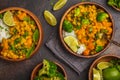 Vegan Sweet Potato Chickpea curry in wooden bowl on a dark background, top view. Healthy vegetarian food concept. Royalty Free Stock Photo