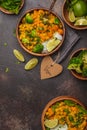 Vegan Sweet Potato Chickpea curry in wooden bowl on a dark background, top view. Healthy vegetarian food concept. Royalty Free Stock Photo