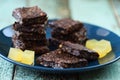 Vegan sweets. Delicious homemade almond brownies and agar jellies on navy blue plate