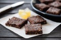 Vegan sweets. Homemade brownie pieces and jelly cubes on navy bl