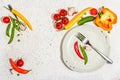 Vegan table setting. Assorted of ripe fresh vegetables, empty plate, cutlery, spices Royalty Free Stock Photo