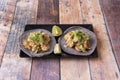 Vegan taco with heura, vegetables, onions and lettuce with parsley and lime for dressing on black plate Royalty Free Stock Photo