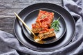 Vegan tofu spinach lasagna on a black plate Royalty Free Stock Photo