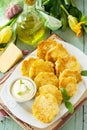 Vegan vegetable fritters zucchini and sour cream garlic sauce on the kitchen wooden table. Royalty Free Stock Photo