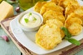 Vegan vegetable fritters zucchini and sour cream garlic sauce on the kitchen wooden table. Royalty Free Stock Photo