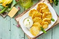 Vegan vegetable fritters zucchini and sour cream garlic sauce on the kitchen wooden table. Royalty Free Stock Photo