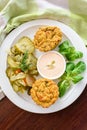 Vegan vegetable muffins with light chili-mayo dip and cucumber pickle salad