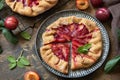 Vegan vegetarian dessert, plums galette with almonds. Healthy homemade wholegrain fruit pie, sweet crostata on a rustic table Royalty Free Stock Photo