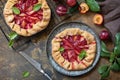 Vegan vegetarian dessert, plums galette with almonds. Healthy homemade wholegrain fruit pie, sweet crostata on a rustic table. Royalty Free Stock Photo