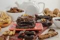 Vegan, vegetarian raw food healthy nut-banana chocolate brownie pastry on a white wooden background. Homemade from dates, walnuts Royalty Free Stock Photo