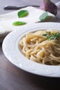 Vegan version of traditional italian pasta fettuccine alfredo with creamy white sauce garnished with basil Royalty Free Stock Photo