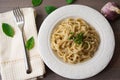 Vegan version of traditional italian pasta fettuccine alfredo with creamy white sauce garnished with basil Royalty Free Stock Photo