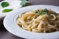 Vegan version of traditional italian pasta fettuccine alfredo with creamy white sauce garnished with basil Royalty Free Stock Photo