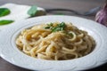 Vegan version of traditional italian pasta fettuccine alfredo with creamy white sauce garnished with basil Royalty Free Stock Photo