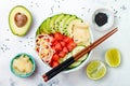 Hawaiian watermelon poke bowl with avocado, cucumber, mung bean sprouts and pickled ginger. Top view, overhead