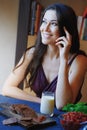 Vegan woman sitting at the table with healthy food