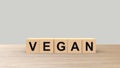 Vegan - word wooden cubes on table horizontal over gray background HD Royalty Free Stock Photo