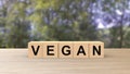 Vegan - word wooden cubes on table horizontal over gray background HD Royalty Free Stock Photo