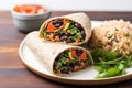 vegan wrap with black beans, brown rice, and vegetables Royalty Free Stock Photo