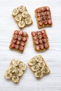 Vegaterian toasts with peanut butter, fruits and chia seeds over white wooden background, top view. Royalty Free Stock Photo