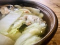 Vege Ball soup in a brown bowl on wooden table. close up view.