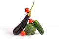 Vegetable art composition. Abstract balancing construction of eggplant, broccoli, cucumber and tomatoes. Royalty Free Stock Photo