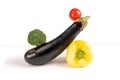 Vegetable art composition. Abstract balancing construction of eggplant, broccoli, pepper and tomato. Royalty Free Stock Photo