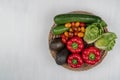 Vegetable basket with tomatoes, red paprikas, zucchini, avocados and salad. Isolated on white background, copy space Royalty Free Stock Photo