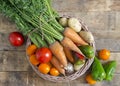 Vegetable basket on a wooden table, in rustic style. Royalty Free Stock Photo