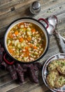 Vegetable bean soup and parmesan cheese toasts on a wooden rustic table, top view. Royalty Free Stock Photo