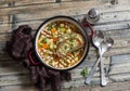 Vegetable bean soup and parmesan cheese toasts on a wooden rustic table, top view. Royalty Free Stock Photo