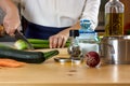 Vegetable broth. Woman cuts the celery and prepares ingredients for cooking vegetable broth. Home made healthy eating