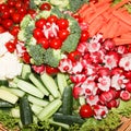 Large vegetable buffet with carrots, radishes and small cherry tomatoes