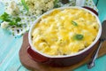 Vegetable casserole cauliflower meat and cheese on a wooden kitchen table, home kitchen