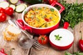 Vegetable casserole in a red pot