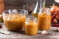 Vegetable caviar in a glass jar on a wooden table