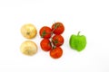 Vegetable composition on a white background - onions, tomatoes red on a branch and green pepper