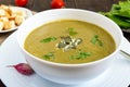 Vegetable cream soup with spinach and potatoes in a white bowl with garlic croutons Royalty Free Stock Photo