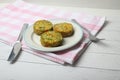 vegetable cutlets on a plate and table-ware on red and white tablecloth
