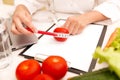 Vegetable diet nutrition or medicaments concept. Female nutrition doctor with vegetables and measuring tape on table