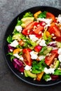 Vegetable dish, salad with avocado, pepper, tomato, italian mix, fresh lettuce, feta cheese and pine nuts. Healthy food Royalty Free Stock Photo