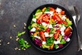 Vegetable dish, salad with avocado, pepper, tomato, italian mix, fresh lettuce, feta cheese and pine nuts. Healthy food Royalty Free Stock Photo