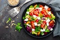 Vegetable dish, salad with avocado, pepper, tomato, italian mix, fresh lettuce, feta cheese and pine nuts. Healthy food Royalty Free Stock Photo