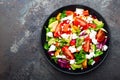 Vegetable dish, salad with avocado, pepper, tomato, italian mix, fresh lettuce, feta cheese and pine nuts. Healthy food Royalty Free Stock Photo