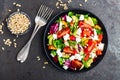 Vegetable dish, salad with avocado, pepper, tomato, italian mix, fresh lettuce, feta cheese and pine nuts. Healthy food Royalty Free Stock Photo