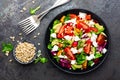 Vegetable dish, salad with avocado, pepper, tomato, italian mix, fresh lettuce, feta cheese and pine nuts. Healthy food Royalty Free Stock Photo