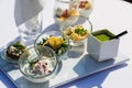 Vegetable, fish and meat snack in glass on table