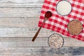 Vegetable food. Closeup of three bowls with rice, buckwheat and quinoa and a spoon with safran spice threads on abstract blurred