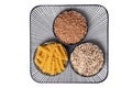 Vegetable food. Macro of a decorative plate with three bowls with buckwheat, noodles and quinoa isolated on a white background.